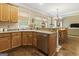 Kitchen features wood cabinetry, stainless appliances, and opens to the sunlit breakfast area at 119 Crown Springs Dr, Mcdonough, GA 30252
