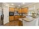 A kitchen with custom wood cabinets, stainless appliances, and stylish pantry door, all with hardwood floors at 119 Crown Springs Dr, Mcdonough, GA 30252