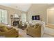 A spacious living room featuring a stone fireplace, vaulted ceiling, plush carpet, and lots of natural light at 119 Crown Springs Dr, Mcdonough, GA 30252