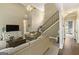 Open-concept living room featuring soaring ceilings, staircase with iron railings, and plush carpeting at 119 Crown Springs Dr, Mcdonough, GA 30252