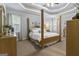 Bright main bedroom features tray ceilings and a four-poster bed, creating a luxurious retreat at 119 Crown Springs Dr, Mcdonough, GA 30252