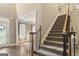 View of the staircase and a glimpse of the dining room at 119 Crown Springs Dr, Mcdonough, GA 30252