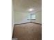 A spacious bedroom with carpet flooring, two windows for natural light, and neutral-colored walls at 105 Harris Ct, Stockbridge, GA 30281