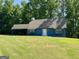 Charming blue home with a well-manicured lawn and a convenient covered carport at 105 Harris Ct, Stockbridge, GA 30281