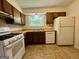 Functional kitchen with white appliances, classic cabinetry, and a bright window over the sink at 105 Harris Ct, Stockbridge, GA 30281
