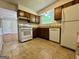 Traditional kitchen featuring white appliances, neutral flooring, and ample cabinet space at 105 Harris Ct, Stockbridge, GA 30281
