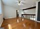 Bright loft area with wood floors, a beamed ceiling, and a view of the lower level at 105 Harris Ct, Stockbridge, GA 30281