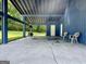 This covered patio has a fireplace, seating and white doors giving access to the interior at 105 Harris Ct, Stockbridge, GA 30281
