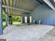 This covered patio has a fireplace, seating and white doors giving access to the interior at 105 Harris Ct, Stockbridge, GA 30281