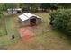 Aerial view of horse barn with lush green grass pasture at 411 Hampton Rd, Fayetteville, GA 30215