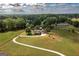 Expansive aerial view of home situated on a sprawling green estate with lush trees and a winding driveway at 411 Hampton Rd, Fayetteville, GA 30215