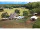 Aerial view of large house and pool with adjacent horse barn at 411 Hampton Rd, Fayetteville, GA 30215