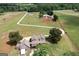 Aerial view of large house and acreage with a pond at 411 Hampton Rd, Fayetteville, GA 30215