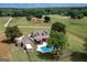 Aerial view of house and pool with horse barn in the distance at 411 Hampton Rd, Fayetteville, GA 30215