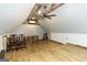 Attic with wood laminate flooring, exposed rustic ceiling, and unique wood and metal railing at 411 Hampton Rd, Fayetteville, GA 30215