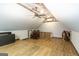Attic with wood laminate flooring, exposed rustic ceiling, seating, and unique wood and metal railing at 411 Hampton Rd, Fayetteville, GA 30215