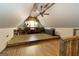 Spacious attic with wood laminate flooring, ceiling fan, work bench, and unique rustic ceiling at 411 Hampton Rd, Fayetteville, GA 30215
