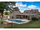 Aerial view of a spacious backyard with pool, deck, shed, and mature trees at 411 Hampton Rd, Fayetteville, GA 30215