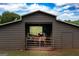 Interior view of horse barn with stalls and access to pasture at 411 Hampton Rd, Fayetteville, GA 30215