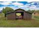 Horse barn with lush green grass perfect for raising horses at 411 Hampton Rd, Fayetteville, GA 30215