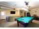 Spacious finished basement with a pool table, seating area, and garage door access at 411 Hampton Rd, Fayetteville, GA 30215