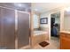Tile bathroom featuring a shower, tub, cabinets, and a closet at 411 Hampton Rd, Fayetteville, GA 30215
