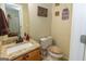 Half bathroom featuring granite countertops and a decorative mirror at 411 Hampton Rd, Fayetteville, GA 30215