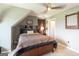 Bedroom with modern ceiling fan, neutral walls, and cozy bedding at 411 Hampton Rd, Fayetteville, GA 30215