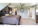 Bedroom with modern ceiling fan, neutral walls, and access to en suite bathroom at 411 Hampton Rd, Fayetteville, GA 30215