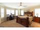 Spacious bedroom featuring elegant wooden furniture and a desk with a large window and plantation shutters at 411 Hampton Rd, Fayetteville, GA 30215