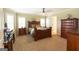 Spacious bedroom featuring elegant wooden furniture and a large window with plantation shutters at 411 Hampton Rd, Fayetteville, GA 30215