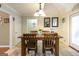 Well-lit dining room with tile floors, dining table, and access to other rooms at 411 Hampton Rd, Fayetteville, GA 30215
