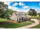 Beautiful home with well-maintained lawn, mature trees, and a charming front porch with rocking chairs at 411 Hampton Rd, Fayetteville, GA 30215