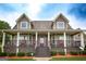 Charming gray two-story home with a welcoming front porch, offering a cozy and inviting curb appeal at 411 Hampton Rd, Fayetteville, GA 30215
