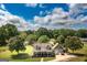A charming home with a lush green lawn and mature trees under a partly cloudy blue sky at 411 Hampton Rd, Fayetteville, GA 30215