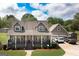 Charming gray two-story home with a welcoming front porch and well-manicured landscaping and detached garage at 411 Hampton Rd, Fayetteville, GA 30215