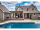 Charming brown house with a spacious wooden deck and an inviting in-ground pool, perfect for relaxation and outdoor entertainment at 411 Hampton Rd, Fayetteville, GA 30215