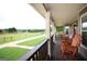 Relaxing front porch with rocking chairs overlooking a lush green field and distant trees at 411 Hampton Rd, Fayetteville, GA 30215