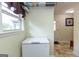 Hallway featuring a freezer, shelf and window, offering extra storage and natural light at 411 Hampton Rd, Fayetteville, GA 30215