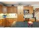 Kitchen features wood cabinets, granite counters, tile backsplash, a desk area and stairs in view at 411 Hampton Rd, Fayetteville, GA 30215