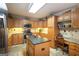 Bright kitchen with wood cabinets, stainless appliances, a center island, and a convenient desk area at 411 Hampton Rd, Fayetteville, GA 30215
