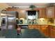 Granite countertops and stainless steel refrigerator in kitchen at 411 Hampton Rd, Fayetteville, GA 30215