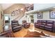 Open living room features hardwood floors, wrought iron stair railing, and comfortable furniture at 411 Hampton Rd, Fayetteville, GA 30215