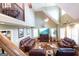 Open concept living room featuring leather sofas and a lofted second story at 411 Hampton Rd, Fayetteville, GA 30215