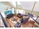 Open-concept living room with hardwood floors, leather furniture, and an abundance of natural light at 411 Hampton Rd, Fayetteville, GA 30215