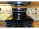 Close up of a modern black glass top oven with stainless steel accents at 411 Hampton Rd, Fayetteville, GA 30215