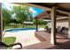 Stylish outdoor space with a covered pergola, a quaint pool, and a manicured lawn, creating a serene and inviting atmosphere at 411 Hampton Rd, Fayetteville, GA 30215
