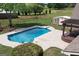 Backyard with in-ground pool, pool-side furniture, shed, and covered deck in a fenced in yard at 411 Hampton Rd, Fayetteville, GA 30215
