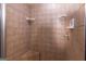 Tiled shower featuring a rainfall shower head and convenient soap and shampoo shelves at 411 Hampton Rd, Fayetteville, GA 30215
