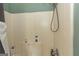 Shower stall featuring a tiled wall and various toiletries on the shower floor at 411 Hampton Rd, Fayetteville, GA 30215